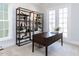 Home office with built-in shelving, a dark wooden desk, and neutral décor at 809 St Charles St, Durham, NC 27713