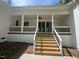 Inviting back porch with stairs and railing, perfect for enjoying the outdoors at 30 Tamaran Ct, Spring Hope, NC 27882