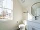 Bright bathroom featuring white fixtures, a large window, and black hardware at 30 Tamaran Ct, Spring Hope, NC 27882