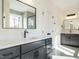 Bright bathroom featuring a double sink vanity with sleek black fixtures and a large framed mirror at 30 Tamaran Ct, Spring Hope, NC 27882