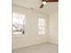 Light-filled bedroom with neutral carpet, dual windows, and a ceiling fan at 30 Tamaran Ct, Spring Hope, NC 27882