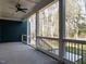 An inviting covered patio with ceiling fan, railing and a view of the wooded backyard creates the perfect spot for relaxing at 30 Tamaran Ct, Spring Hope, NC 27882