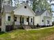 Charming home exterior featuring a welcoming front porch, beautiful landscaping, and well-maintained lawn at 30 Tamaran Ct, Spring Hope, NC 27882