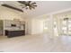 Bright, open-concept living area featuring a modern kitchen, wood floors, and a striking ceiling fan at 30 Tamaran Ct, Spring Hope, NC 27882