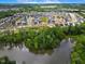 Picturesque aerial view of a residential community nestled alongside a tranquil lake at 3102 Castlerock Dr # 2, Burlington, NC 27215