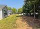 Well-manicured lawn with lush trees, inviting patio furniture, and charming surroundings at 3102 Castlerock Dr # 2, Burlington, NC 27215