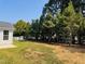 Spacious backyard featuring a lush lawn, mature trees, and inviting outdoor seating at 3102 Castlerock Dr # 2, Burlington, NC 27215