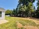 Spacious backyard featuring a lush lawn, mature trees, and inviting outdoor seating at 3102 Castlerock Dr # 2, Burlington, NC 27215