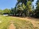 Expansive backyard featuring a lush lawn and mature trees, perfect for outdoor activities at 3102 Castlerock Dr # 2, Burlington, NC 27215