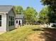 Serene backyard showcasing a landscaped area, outdoor seating, and a charming storage building at 3102 Castlerock Dr # 2, Burlington, NC 27215