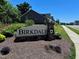 Birkdale community sign with lush landscaping against a backdrop of modern homes and blue sky at 3102 Castlerock Dr # 2, Burlington, NC 27215