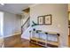 Inviting entryway with hardwood floors, console table, and staircase at 3102 Castlerock Dr # 2, Burlington, NC 27215