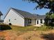 Well-maintained home exterior with neutral siding, a dark roof, and a cozy patio area at 3102 Castlerock Dr # 2, Burlington, NC 27215