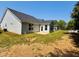 Home exterior featuring a well manicured lawn, a bright sunroom, and backyard seating at 3102 Castlerock Dr # 2, Burlington, NC 27215