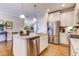 Open kitchen boasts stainless appliances, granite counters, and kitchen island at 3102 Castlerock Dr # 2, Burlington, NC 27215
