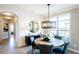 Bright dining area with a round table, chandelier, and built-in cabinetry at 1005 Bridgeforth Ln, Chapel Hill, NC 27517
