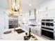 Modern kitchen with white cabinets, stainless steel appliances and a large island at 1005 Bridgeforth Ln, Chapel Hill, NC 27517