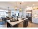 Open concept kitchen with white cabinets, island, and stainless steel appliances at 1005 Bridgeforth Ln, Chapel Hill, NC 27517