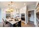 Modern kitchen with white cabinets, stainless steel appliances, and large island at 1005 Bridgeforth Ln, Chapel Hill, NC 27517