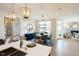 Open kitchen with island, white cabinets, and gold light fixtures at 1005 Bridgeforth Ln, Chapel Hill, NC 27517