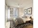 Bright bedroom with a ceiling fan, large window, and a cozy bed adorned with decorative pillows at 106 Broadway St # 106, Durham, NC 27701