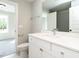 Bathroom featuring a modern sink, vanity, and a gray tiled shower at 1000 Azalea Garden Circle, Raleigh, NC 27603