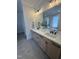 A bright bathroom with double vanity, matte black hardware, and a glass shower at 1000 Azalea Garden Circle, Raleigh, NC 27603