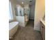 Bathroom featuring a standalone tub, glass shower, and modern fixtures at 1000 Azalea Garden Circle, Raleigh, NC 27603