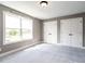 Bedroom featuring a window with a scenic view and double closets at 1000 Azalea Garden Circle, Raleigh, NC 27603