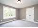 This bedroom features a window and double closet for storage at 1000 Azalea Garden Circle, Raleigh, NC 27603