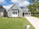 Charming two-story home with beautiful landscaping and covered porch at 1000 Azalea Garden Circle, Raleigh, NC 27603