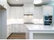 Modern kitchen featuring white cabinetry, stainless steel appliances, and an elegant center island at 1000 Azalea Garden Circle, Raleigh, NC 27603