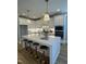 Bright kitchen featuring an island with bar stool seating and stylish pendant lighting at 1000 Azalea Garden Circle, Raleigh, NC 27603