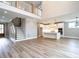 Bright, open-concept living space with a modern staircase and gourmet kitchen featuring stainless steel appliances at 1000 Azalea Garden Circle, Raleigh, NC 27603