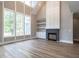 Spacious living room with tall windows, a modern fireplace, and built-in shelving at 1000 Azalea Garden Circle, Raleigh, NC 27603
