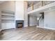 Bright living room with fireplace, built-in shelving, and access to the upper level at 1000 Azalea Garden Circle, Raleigh, NC 27603