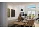 Bright dining room with modern lighting, sleek black television, and access to outdoor deck at 106 Broadway St # 202, Durham, NC 27701