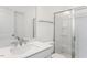 Bright bathroom featuring a glass shower, chrome hardware, and a single vanity sink at 736 Heathered Farm Way, Apex, NC 27523
