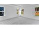 Large bedroom with tray ceiling, carpet, neutral paint, and three windows at 736 Heathered Farm Way, Apex, NC 27523