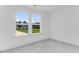 Bright bedroom with two windows bringing in natural light, neutral paint, and carpet at 736 Heathered Farm Way, Apex, NC 27523