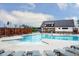 Inviting community pool with a splash pad, modern lounge chairs, and a stylish clubhouse for social gatherings at 736 Heathered Farm Way, Apex, NC 27523