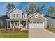 Beautiful two-story home featuring a two-car garage, manicured lawn, and a covered front porch at 736 Heathered Farm Way, Apex, NC 27523