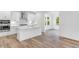 Bright kitchen with stainless steel appliances, a center island and stylish backsplash at 736 Heathered Farm Way, Apex, NC 27523