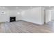Spacious living room with fireplace, modern lighting, and wood-style floors at 736 Heathered Farm Way, Apex, NC 27523