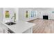 Open concept living room with fireplace, large windows, and stylish flooring at 736 Heathered Farm Way, Apex, NC 27523