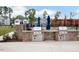 Community outdoor kitchen featuring built-in grills and brick surround at 736 Heathered Farm Way, Apex, NC 27523