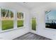 Bright sunroom with multiple windows overlooking a green lawn at 736 Heathered Farm Way, Apex, NC 27523