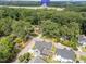 Aerial shot highlighting the residence's location surrounded by mature trees, and city access at 1000 Marilyn Dr, Raleigh, NC 27607