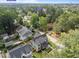 A drone shot showcases a newly constructed residence with dark roof amidst lush greenery at 1000 Marilyn Dr, Raleigh, NC 27607