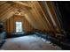 Unfinished attic space with exposed beams, a window, and HVAC ductwork, great for storage at 1000 Marilyn Dr, Raleigh, NC 27607
